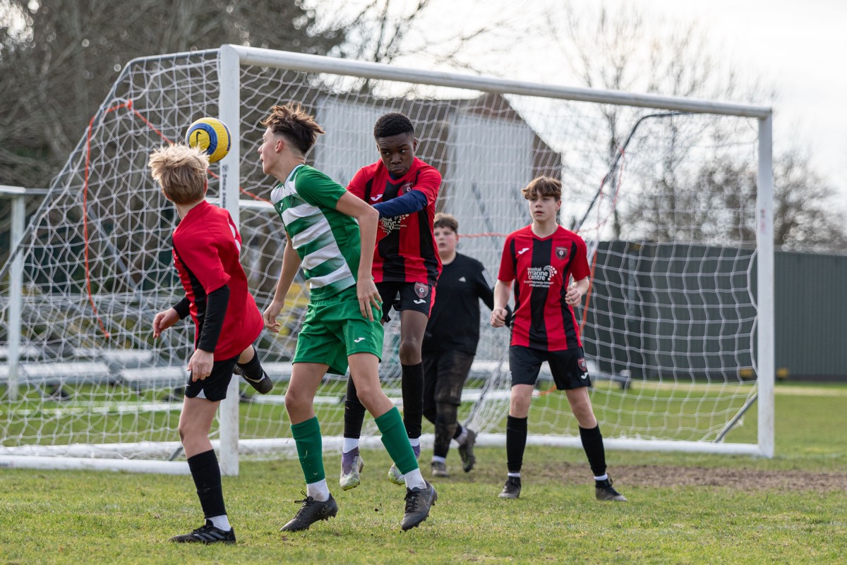 Lions player shielding the ball from a Chipstead opponent